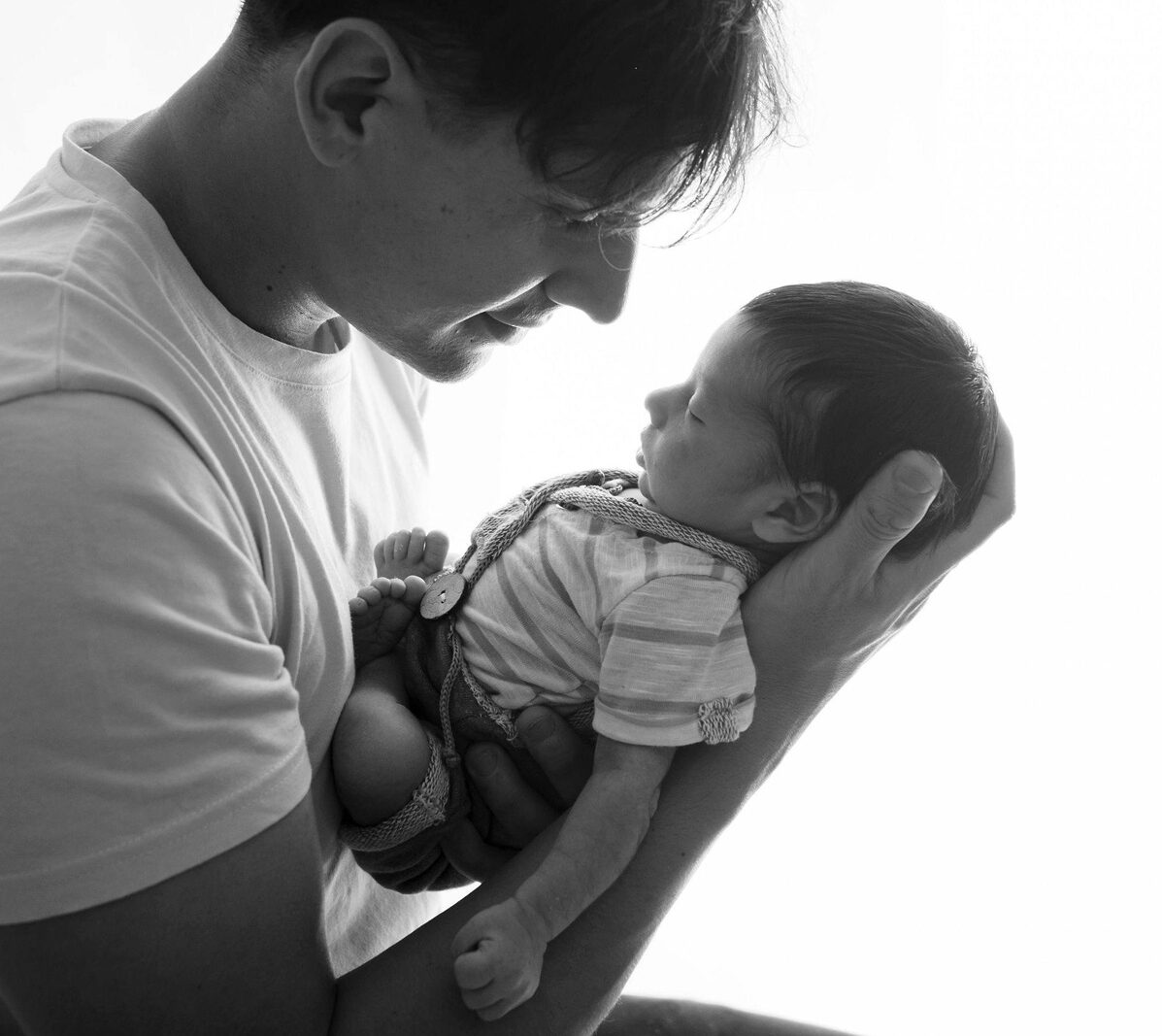 first time father holding newborn baby